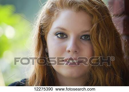 Portrait of a young woman with long red hair; United States of America View Large Photo Image Stock Image - Portrait of a young woman with long red hair; United States of America. Fotosearch