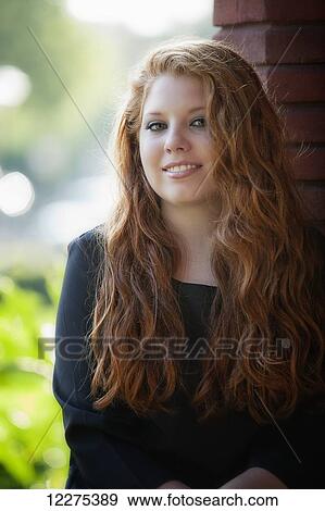 Portrait of a young woman with long red hair; United States of America View Large Photo Image Stock Photo - Portrait of a young woman with long red hair; United States of America. Fotosearch