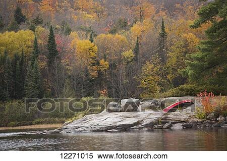 Red canoe sitting on the rocks surrounding Rock Lake, Algonquin Park; Ontario, Canada View Large Photo Image Stock Photography - Red canoe sitting on the rocks surrounding Rock Lake, Algonquin Park; Ontario, Canada. Fotosearch