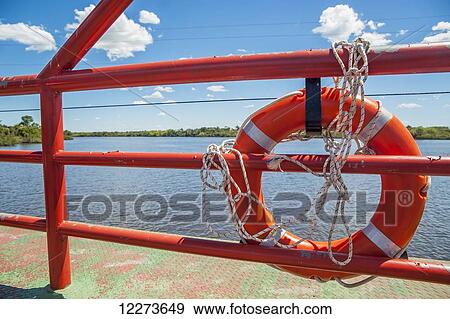 Red railing and life preserver at the river crossing near Cebollati; Uruguay View Large Photo Image Stock Photo - Red railing and life preserver at the river crossing near Cebollati; Uruguay. Fotosearch