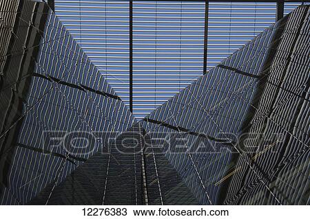 Stock Image - Reflections of lattice work in the atrium of 6 More London Place on the South Bank; London, England. Fotosearch
