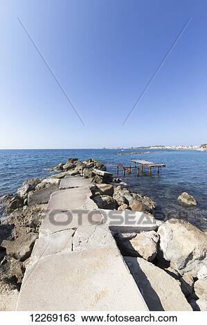 Rock path leading out to the Mediterranean sea; Paphos, Cyprus View Large Photo Image Stock Image - Rock path leading out to the Mediterranean sea; Paphos, Cyprus. Fotosearch