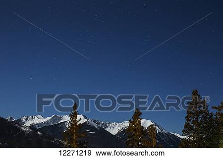Rocky Mountains at night in winter; Banff, Alberta, Canada View Large Photo Image Stock Photo - Rocky Mountains at night in winter; Banff, Alberta, Canada. Fotosearch