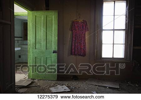 Room inside an old abandoned house with a green door open and an old dress hanging on the wall; United States of America View Large Photo Image Stock Photo - Room inside an old abandoned house with a green door open and an old dress hanging on the wall; United States of America. Fotosearch