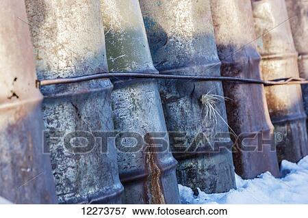 Row of rusted and weathered 55 gallon drums in winter; Noatak, Alaska, United States of America View Large Photo Image Stock Photo - Row of rusted and weathered 55 gallon drums in winter; Noatak, Alaska, United States of America. Fotosearch