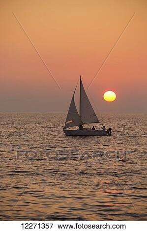 Sailboat sailing at sunset; Wailea, Maui, Hawaii, United States of America View Large Photo Image Stock Photo - Sailboat sailing at sunset; Wailea, Maui, Hawaii, United States of America. Fotosearch