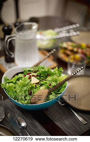 Stock Photo - Salad on a table set for dinnertime; Vancouver, British Columbia, Canada. Fotosearch