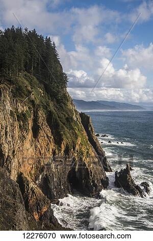 Stock Image - Scattered clouds pass over the Oregon coast; Manzanita, Oregon, United States of America. Fotosearch