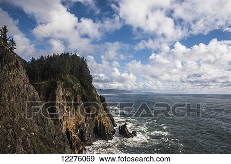 Scattered clouds pass over the Oregon coast; Manzanita, Oregon, United States of America View Large Photo Image Stock Photo - Scattered clouds pass over the Oregon coast; Manzanita, Oregon, United States of America. Fotosearch