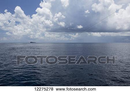 Stock Photo - Ship seen in the distance on the pacific ocean; Tahiti. Fotosearch