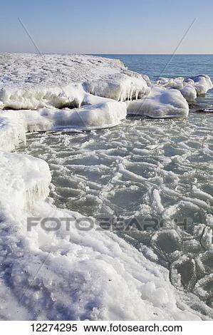Stock Photography - Shoreline at Kew Beach on Lake Ontario during spring thaw; Toronto, Ontario, Canada. Fotosearch