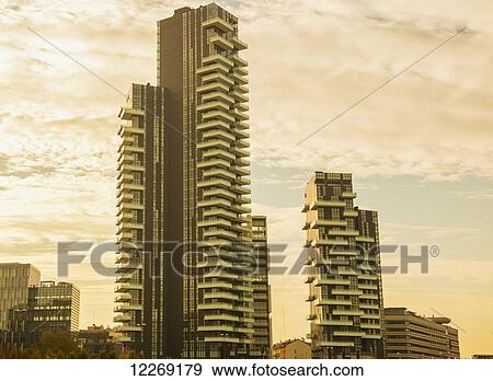 Skyscrapers against cloud at sunset; Milan, Lombardy, Italy View Large Photo Image Stock Photo - Skyscrapers against cloud at sunset; Milan, Lombardy, Italy. Fotosearch