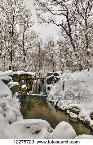 Stock Photo - Snow-covered waterfall in The Loch, Central Park; New York City, New York, United States of America. Fotosearch