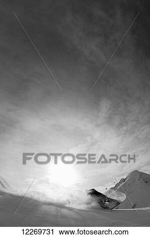 Stock Image - Snowboarding on the snow covered mountains; Haines, Alaska, United States of America. Fotosearch