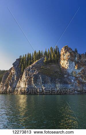 Spruce trees top the cliffs of the Lower Canyon of the Noatak River; Noatak, Alaska, United States of America View Large Photo Image Stock Image - Spruce trees top the cliffs of the Lower Canyon of the Noatak River; Noatak, Alaska, United States of America. Fotosearch