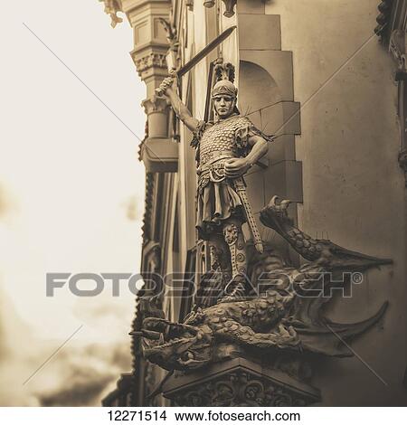 Statue on the side of a building of a warrior slaying a dragon; Prague, Czech Republic View Large Photo Image Picture - Statue on the side of a building of a warrior slaying a dragon; Prague, Czech Republic. Fotosearch