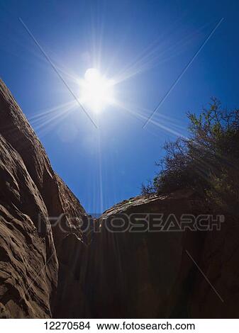 Sun star over a canyon silhouette; Hanksville, Utah, United States of America View Large Photo Image Picture - Sun star over a canyon silhouette; Hanksville, Utah, United States of America. Fotosearch