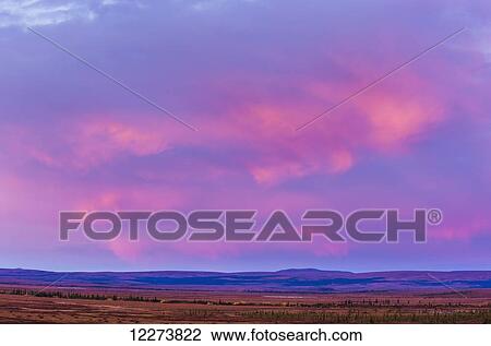 Sunrise alpenglow on the clouds above the arctic tundra in autumn; Noatak, Alaska, United States of America View Large Photo Image Stock Image - Sunrise alpenglow on the clouds above the arctic tundra in autumn; Noatak, Alaska, United States of America. Fotosearch