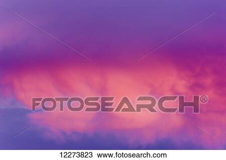 Stock Image - Sunrise alpenglow on the clouds; Noatak, Alaska, United States of America. Fotosearch