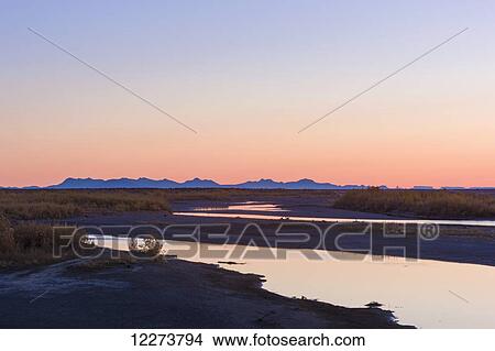 Picture - Sunrise over the Noatak River, Baird mountains in the distance; Noatak, Alaska, United States of America. Fotosearch
