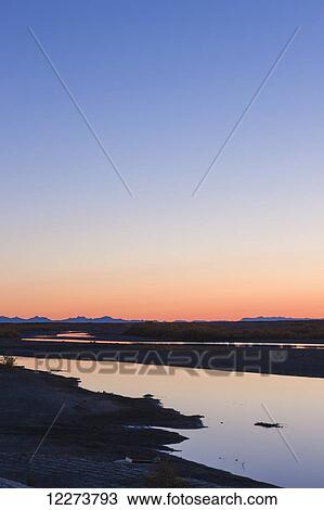 Stock Image - Sunrise over the Noatak River, Baird mountains in the distance; Noatak, Alaska, United States of America. Fotosearch