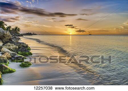 Stock Photo - Sunset over Dickenson Bay; St. John's, Antigua, West Indies. Fotosearch