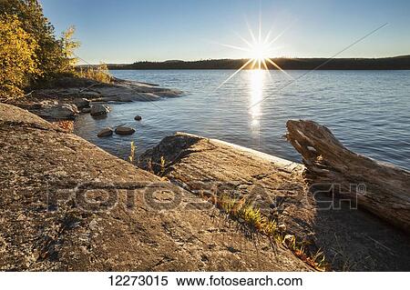 Sunset over lake with rocks; Thunder Bay, Ontario, Canada View Large Photo Image Stock Photography - Sunset over lake with rocks; Thunder Bay, Ontario, Canada. Fotosearch