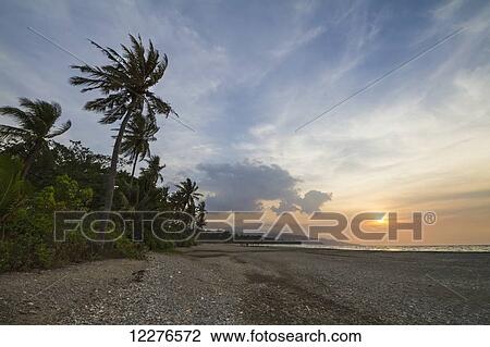 Stock Image - Sunset over the Wetar Strait; Dili, East Timor. Fotosearch