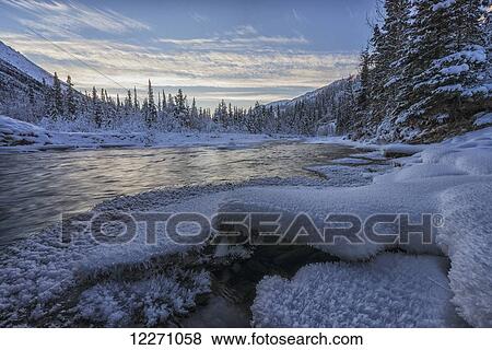 Stock Photo - Sunset over the Wheaton River, near Whitehorse; Yukon, Canada. Fotosearch