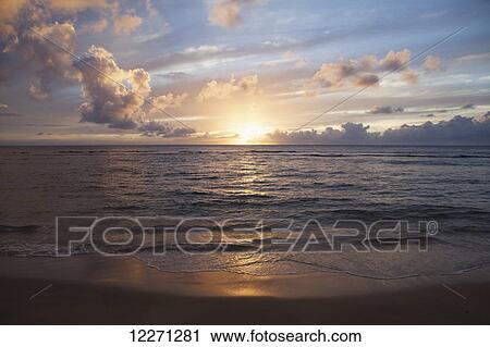 Sunset over water, Kee Beach at Haena Beach State Park; Haena, Kauai, Hawaii, United States of America View Large Photo Image Stock Image - Sunset over water, Kee Beach at Haena Beach State Park; Haena, Kauai, Hawaii, United States of America. Fotosearch