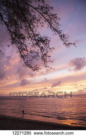 Sunset over water, Kee Beach at Haena Beach State Park; Haena, Kauai, Hawaii, United States of America View Large Photo Image Stock Photography - Sunset over water, Kee Beach at Haena Beach State Park; Haena, Kauai, Hawaii, United States of America. Fotosearch