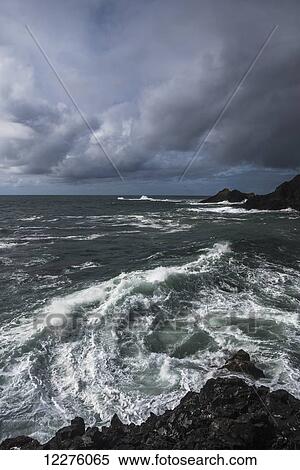 Stock Photography - Surf breaks on a stormy afternoon; Manzanita, Oregon, United States of America. Fotosearch