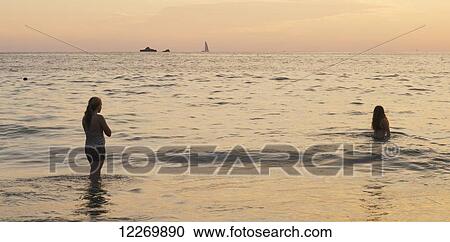 Swimming in the ocean at sunset with boats in the distance; Ixtapa-Zihuatanejo, Guerrero, Mexico View Large Photo Image Stock Image - Swimming in the ocean at sunset with boats in the distance; Ixtapa-Zihuatanejo, Guerrero, Mexico. Fotosearch