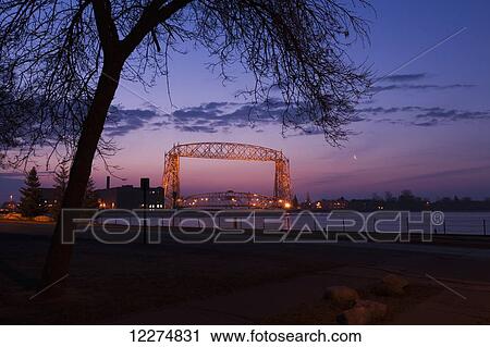 The aerial lift bridge and harbor at dawn; Duluth, Minnesota, United States of America View Large Photo Image Stock Image - The aerial lift bridge and harbor at dawn; Duluth, Minnesota, United States of America. Fotosearch