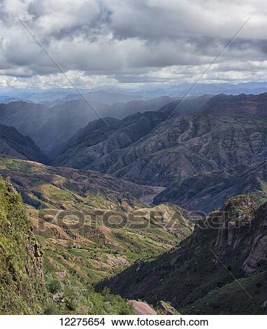 The colourful mountainous landscape of Toro Toro National Park, with a rainstorm in the distance; Bolivia View Large Photo Image Picture - The colourful mountainous landscape of Toro Toro National Park, with a rainstorm in the distance; Bolivia. Fotosearch