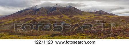 Stock Image - The multi-coloured hills and mountains along the Dempster Highway, near Dawson City; Yukon, Canada. Fotosearch