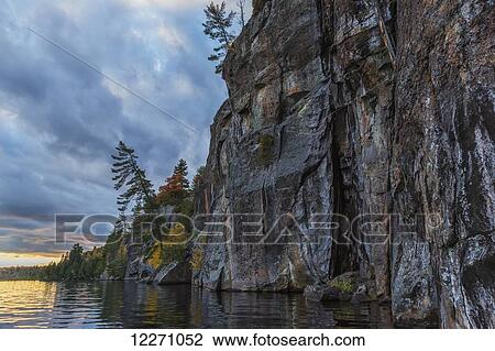 The painted cliffs of Rock Lake at sunset in Algonquin Park; Ontario, Canada View Large Photo Image Stock Image - The painted cliffs of Rock Lake at sunset in Algonquin Park; Ontario, Canada. Fotosearch