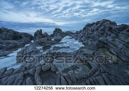 Stock Photograph - The volcanic bedrock near Tow Hill at dawn, Naikoon Provincial Park, Haida Gwaii; Masset, British Columbia, Canada. Fotosearch