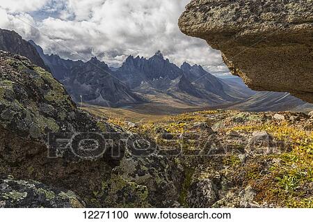 Tombstone Mountain is framed by rocks in this view within Tombstone Territorial Park; Yukon, Canada View Large Photo Image Stock Image - Tombstone Mountain is framed by rocks in this view within Tombstone Territorial Park; Yukon, Canada. Fotosearch