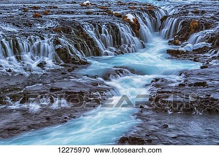 Turquoise water flowing over rocks into a river; Bruarfoss, Iceland View Large Photo Image Stock Image - Turquoise water flowing over rocks into a river; Bruarfoss, Iceland. Fotosearch
