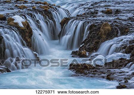 Turquoise water flowing over rocks into a river; Bruarfoss, Iceland View Large Photo Image Stock Image - Turquoise water flowing over rocks into a river; Bruarfoss, Iceland. Fotosearch