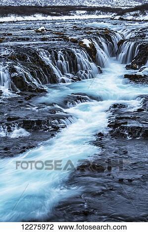 Turquoise water flowing over rocks into a river; Bruarfoss, Iceland View Large Photo Image Stock Image - Turquoise water flowing over rocks into a river; Bruarfoss, Iceland. Fotosearch