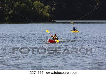 Stock Photo - Two people kayaking on Lake Macbride in Lake Macbride State Park, near Solon; Iowa, United States of America. Fotosearch