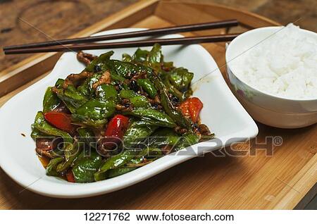 Stock Image - Typical Chinese green pepper and pork called HuiGuoRou; Wuhan, Hubei province, China. Fotosearch