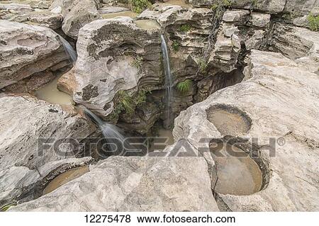 Stock Photo - Uniquely carved rocks around a waterfall in Toro Toro National Park; Bolivia. Fotosearch