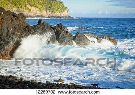Wave crashing against the rocks along the coastline; Island of Hawaii, Hawaii, United States of America View Large Photo Image Stock Image - Wave crashing against the rocks along the coastline; Island of Hawaii, Hawaii, United States of America. Fotosearch