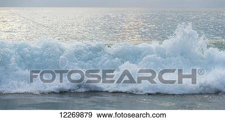 Waves crashing and breaking on the shore at sunset; Guerrero, Mexico View Large Photo Image Stock Photo - Waves crashing and breaking on the shore at sunset; Guerrero, Mexico. Fotosearch