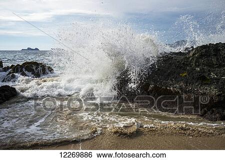 Waves crashing on the shore and rock formations in the ocean in the distance; Ixtapa-Zihuatanejo, Guerrero, Mexico View Large Photo Image Stock Photograph - Waves crashing on the shore and rock formations in the ocean in the distance; Ixtapa-Zihuatanejo, Guerrero, Mexico. Fotosearch
