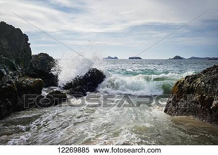 Waves crashing on the shore and rock formations in the ocean in the distance; Ixtapa-Zihuatanejo, Guerrero, Mexico View Large Photo Image Stock Photography - Waves crashing on the shore and rock formations in the ocean in the distance; Ixtapa-Zihuatanejo, Guerrero, Mexico. Fotosearch