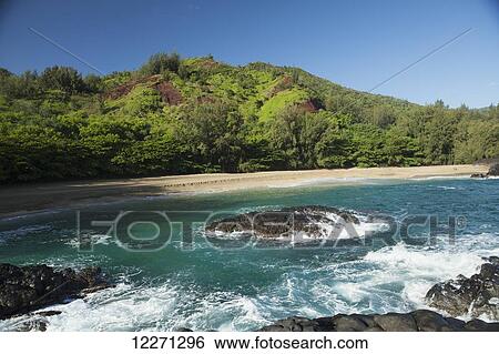 Stock Photograph - Waves on rocks at Lumahai Beach and Valley; Kauai, Hawaii, United States of America. Fotosearch
